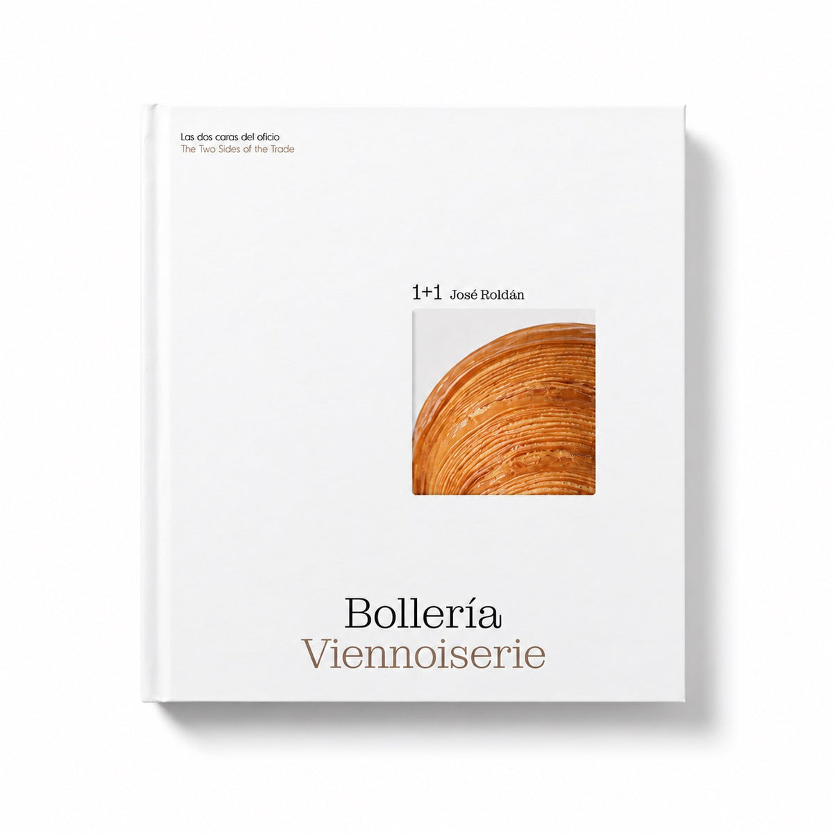 A hardcover book titled 'Bollería Viennoiserie' by José Rodén, published by 1+1, featuring a minimalist white cover with a small square photograph of a golden-brown pastry crust and elegant typography.