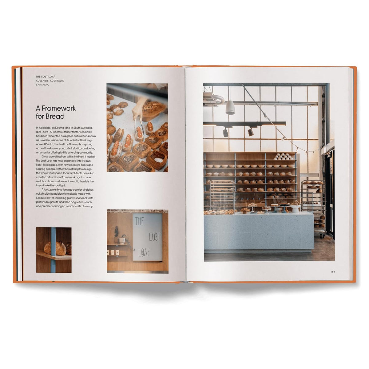 An open book or magazine spread shown against a white background. The left page contains text and small food photography, and the right page shows a large interior bakery scene with shelves, bread racks, and a counter.