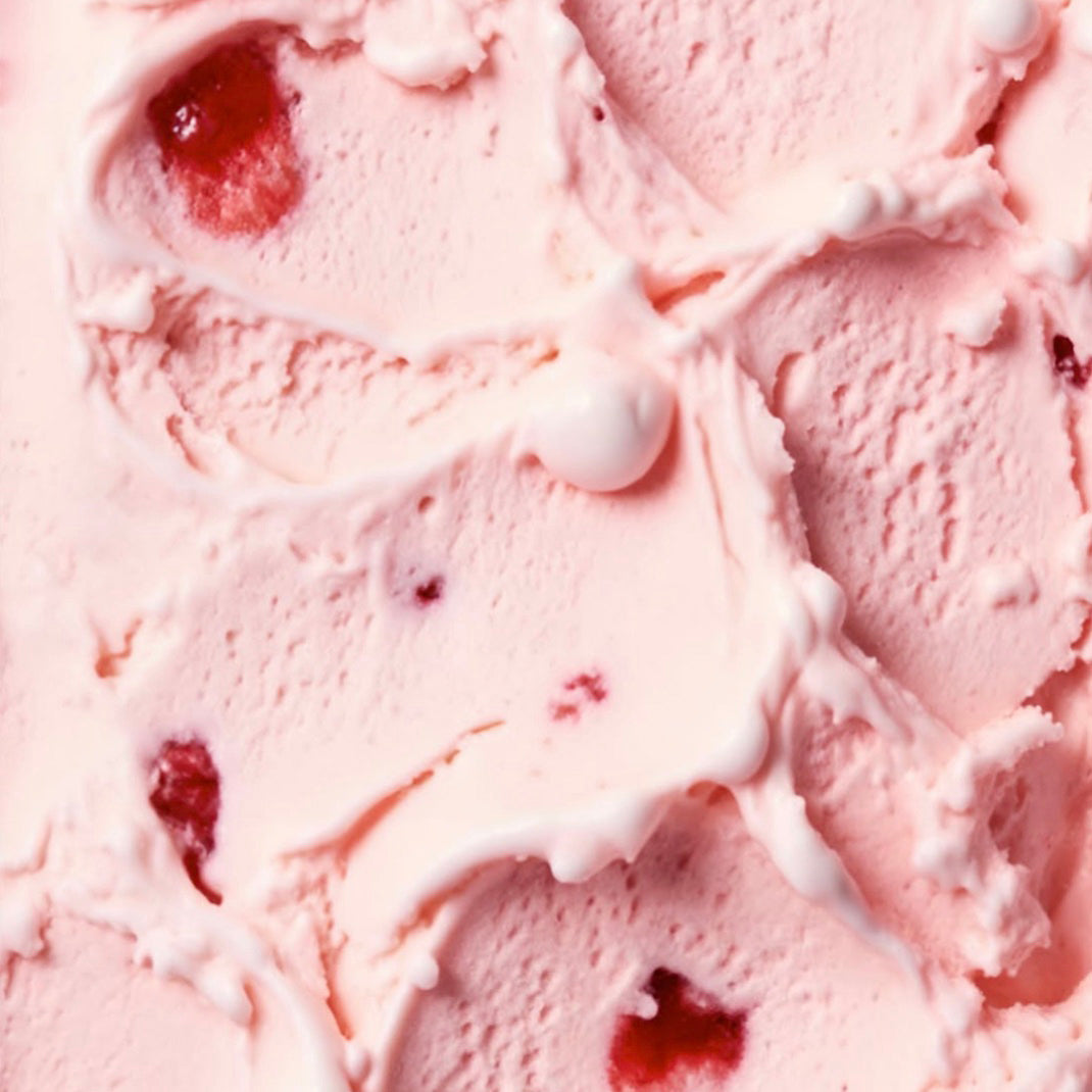 A close-up texture shot of light pink strawberry ice cream with visible red fruit pieces and swirls.