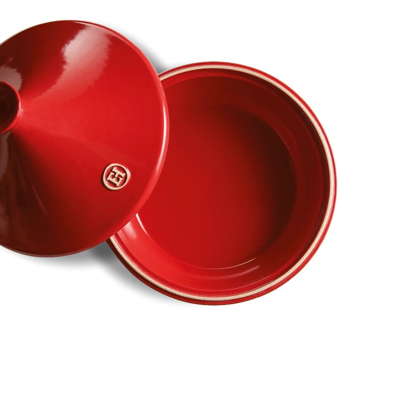 Red grand cru ceramic tagine with a lid and a Emile Henry logo on a white background