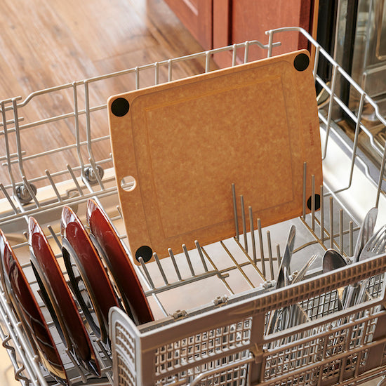 Dishwasher with cutlery and a Epicurean all-in-one cutting board inside