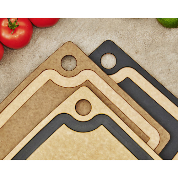 Three Epicurean gourmet series cutting boards with juice groove on a surface with tomatoes and a lime.