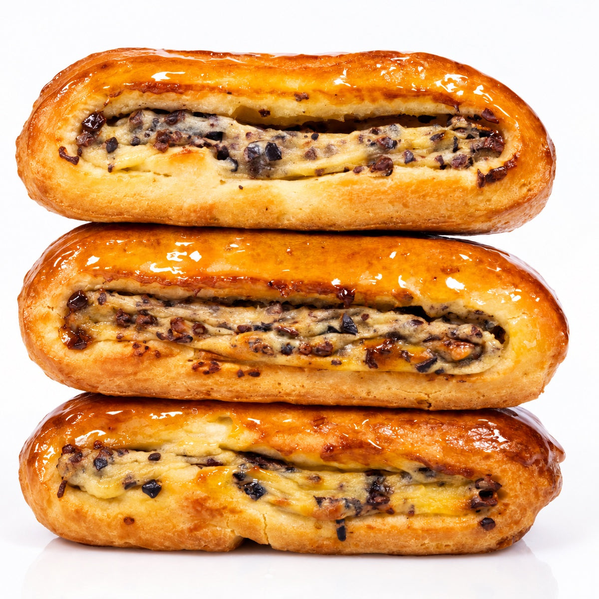 Three golden-brown baked pastries stacked vertically on a clean white background, each showing a glossy glaze and a dark chocolate chip filling.
