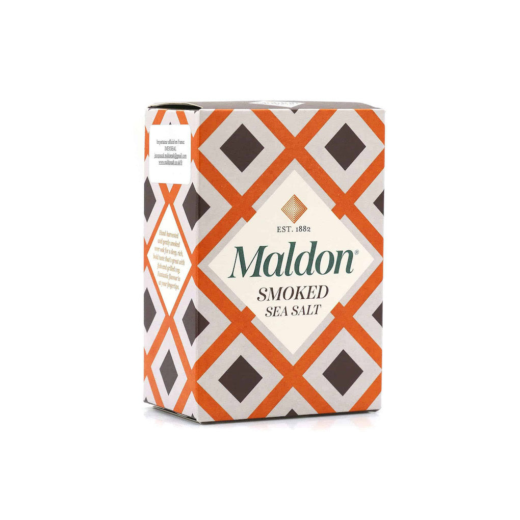 A box of Maldon Smoked Sea Salt with a geometric pattern of orange, dark brown, and white diamonds, on a clean white background.