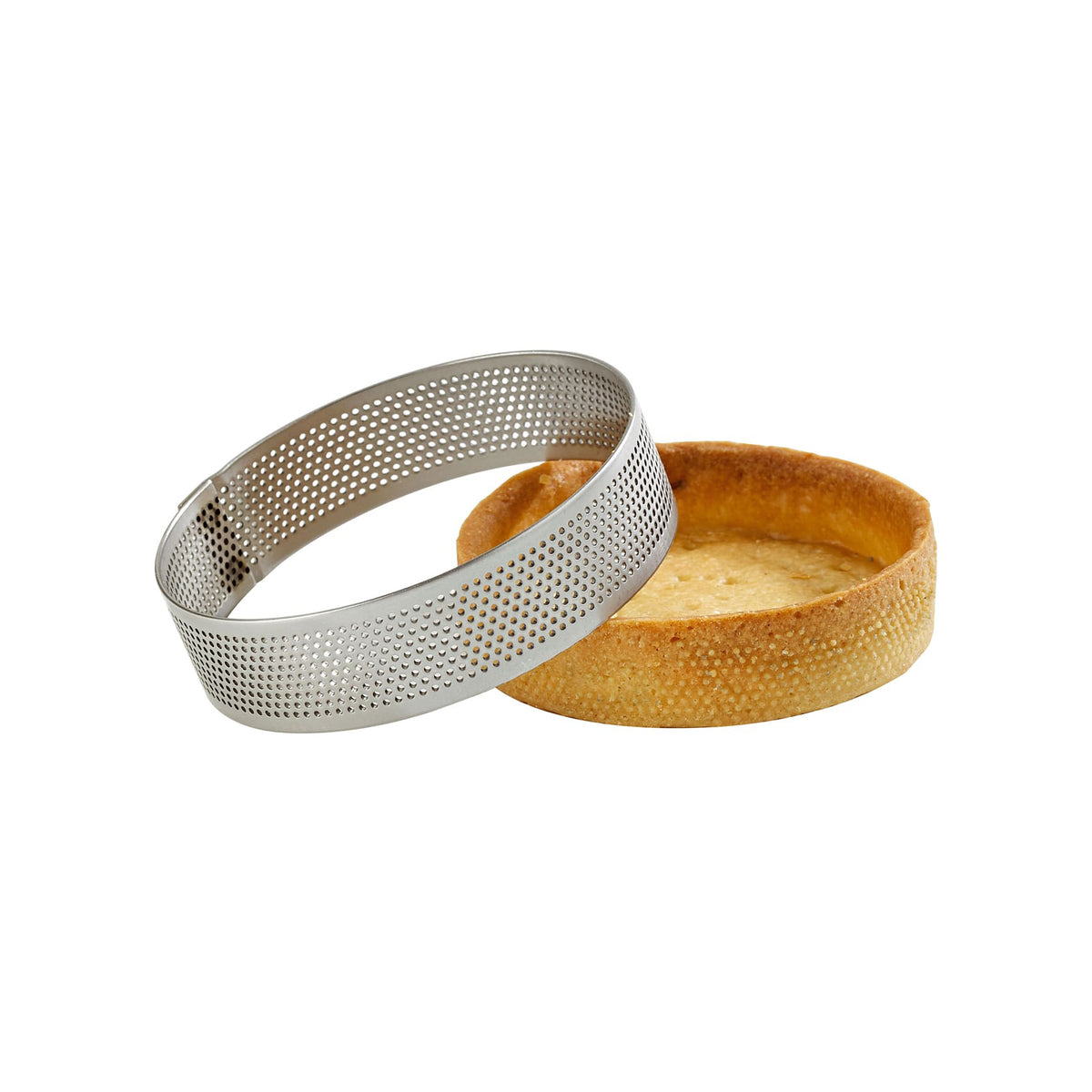 A silver Mallard Ferriere stainless steel tart ring with a perforated mesh design, shown alongside a golden-brown baked tart shell on a plain white background.