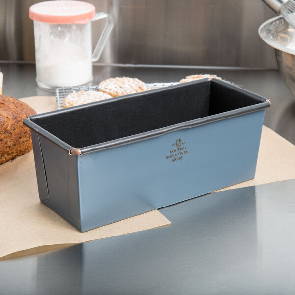 Matfer bread loaf pan on a kitchen counter with baked goods in the background