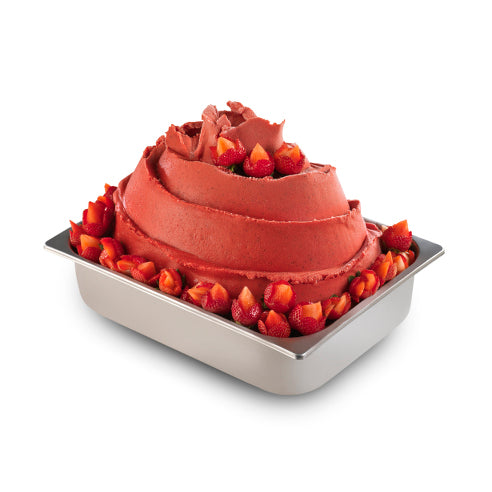 A chocolate cake with red strawberry frosting and strawberry garnish, presented in a square metal baking pan on a white background.