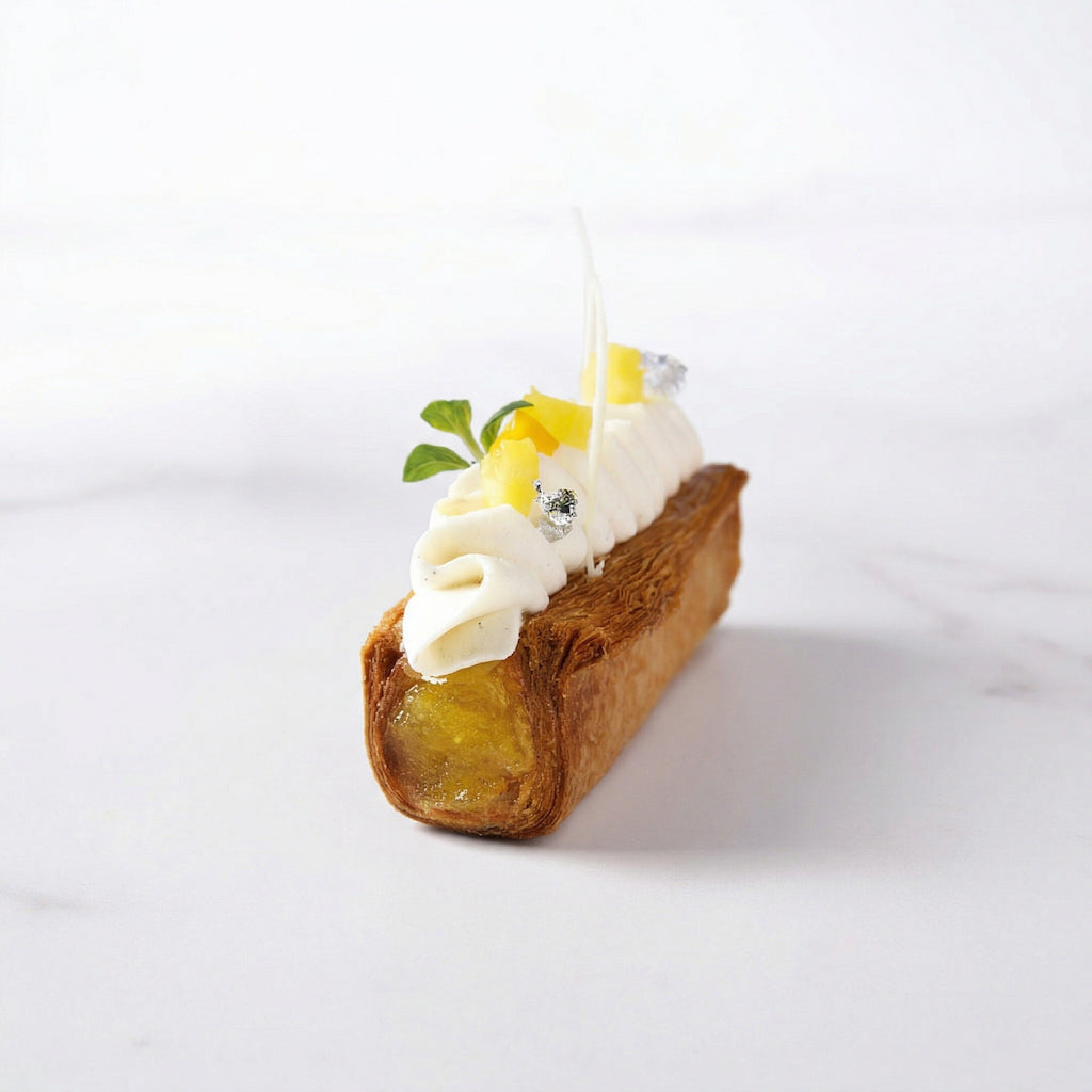 Small dessert with cream and pineapple fruit filling on a white background
