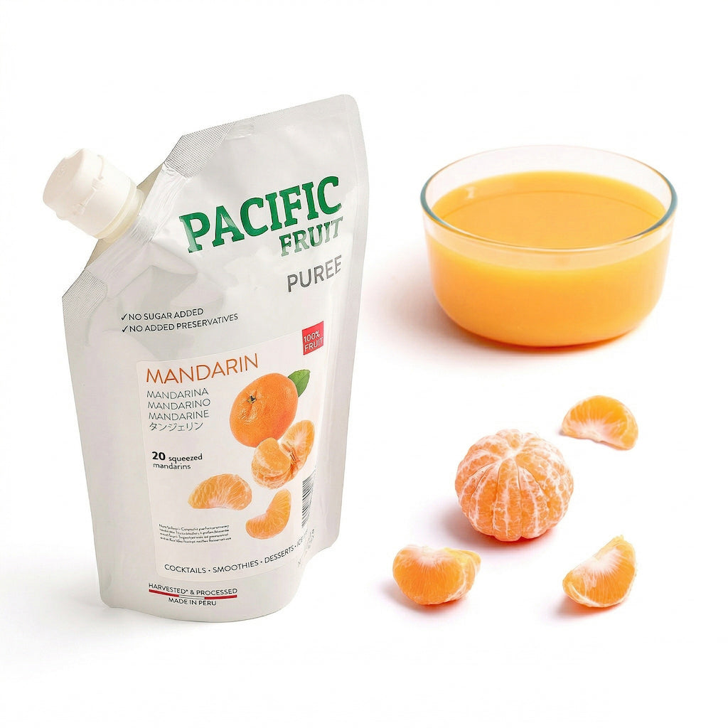Pacific Fruit Mandarin puree pouch with a glass of mandarin / tangerine juice and mandarin slices on a white background