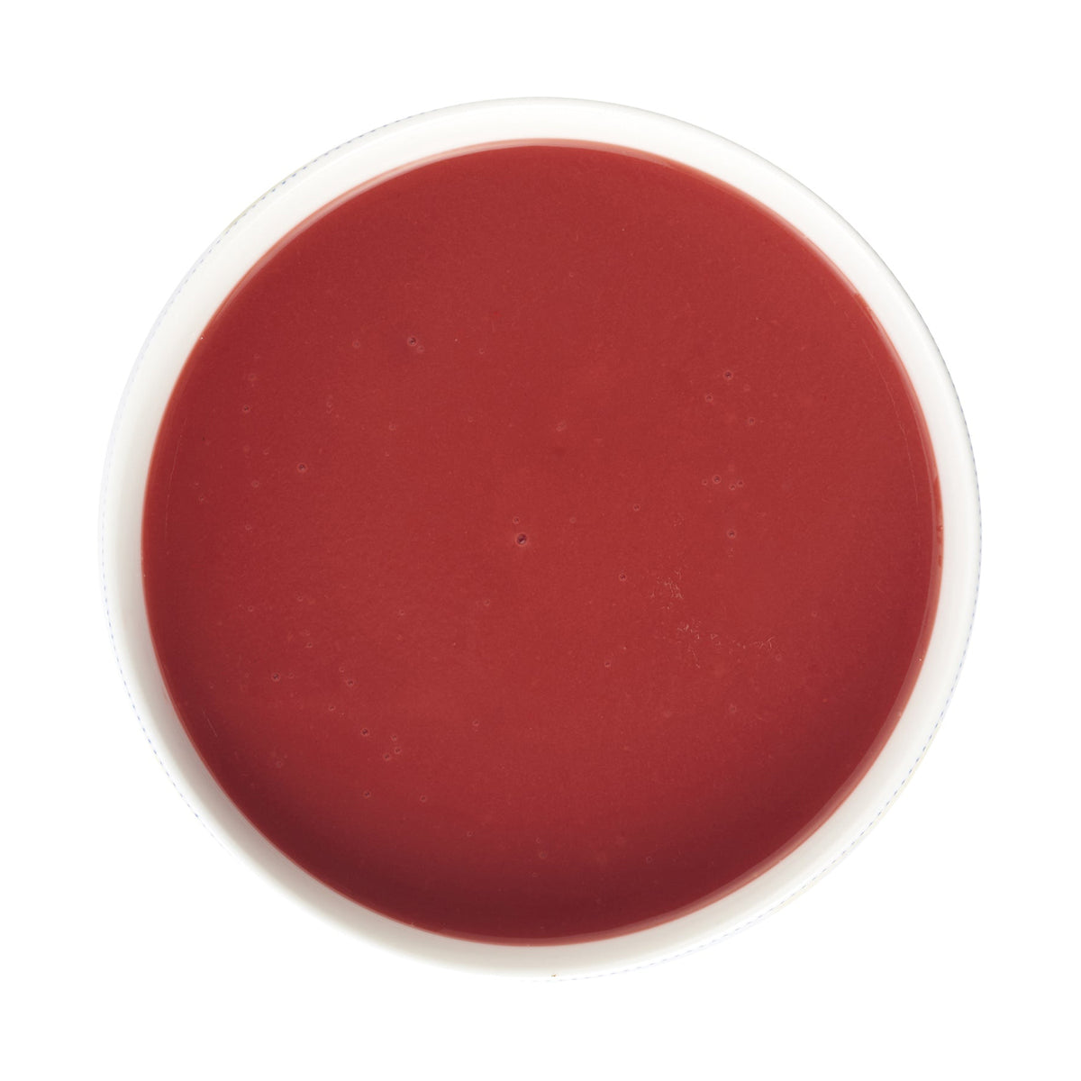 Red bowl of Pacific Fruit strawberry puree on a white background