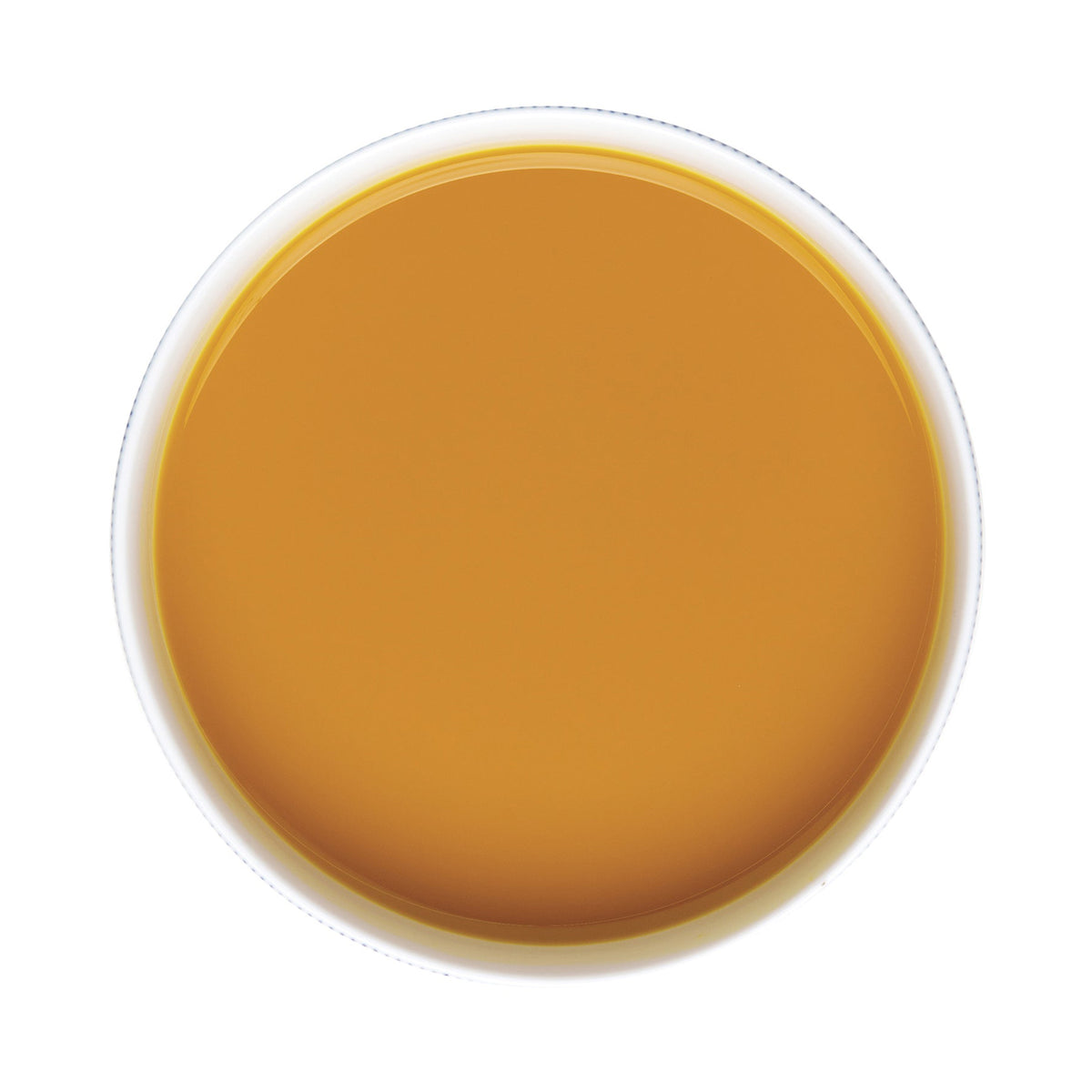 Top-down view of a white cup filled with a Pacific Fruit turmeric puree juice on a white background
