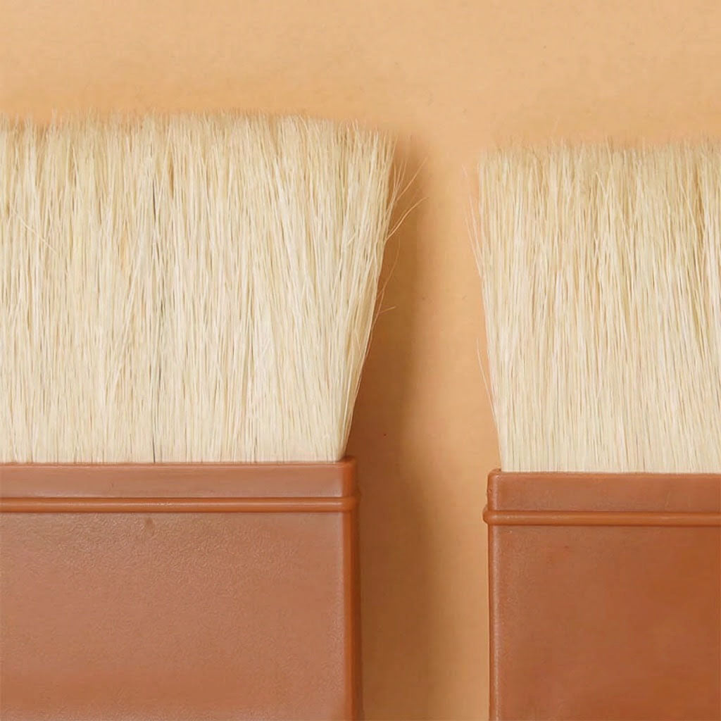 Two paint brushes with Sanneng bristle heads against a beige background