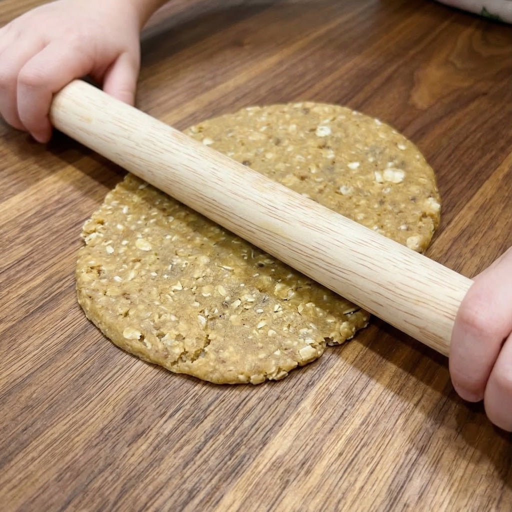 Person rolling out dough with a Sanneng small wooden rolling pin SN8030 on a wooden surface