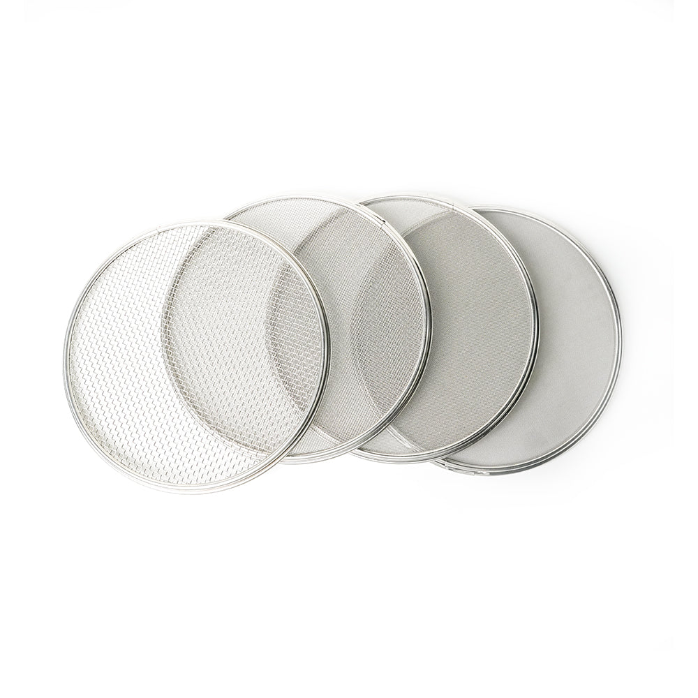 Set of four round metal sieves on a white background