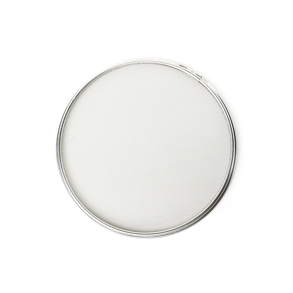 Round metal mesh filter on a white background