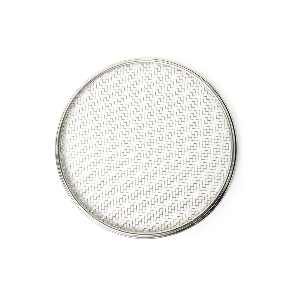 Round metal mesh filter on a white background