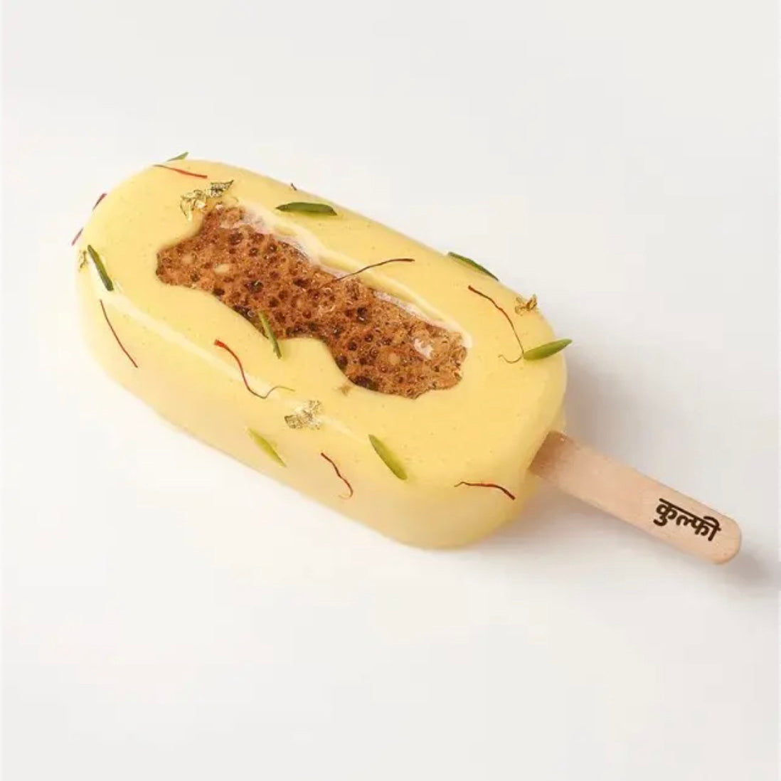 Pineapple-shaped ice cream bar with a wooden stick on a white background