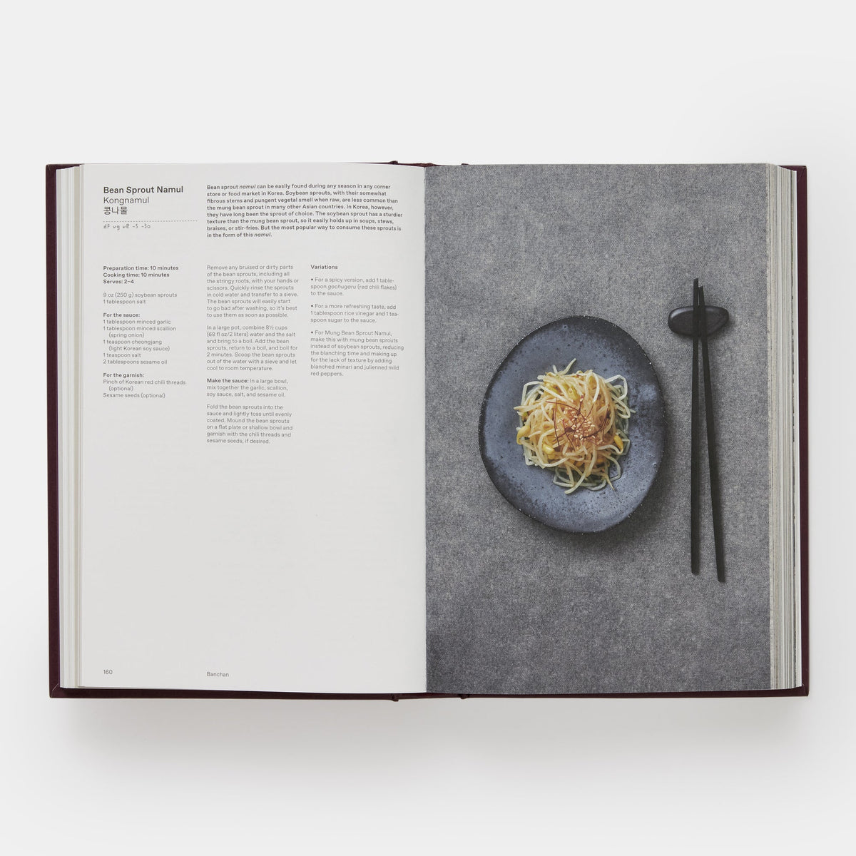 An open recipe book showing a page for Bean Sprout Noodle, with printed text on the left and a styled food photograph on the right of noodles on a dark plate with chopsticks, photographed from above on a light gray background.