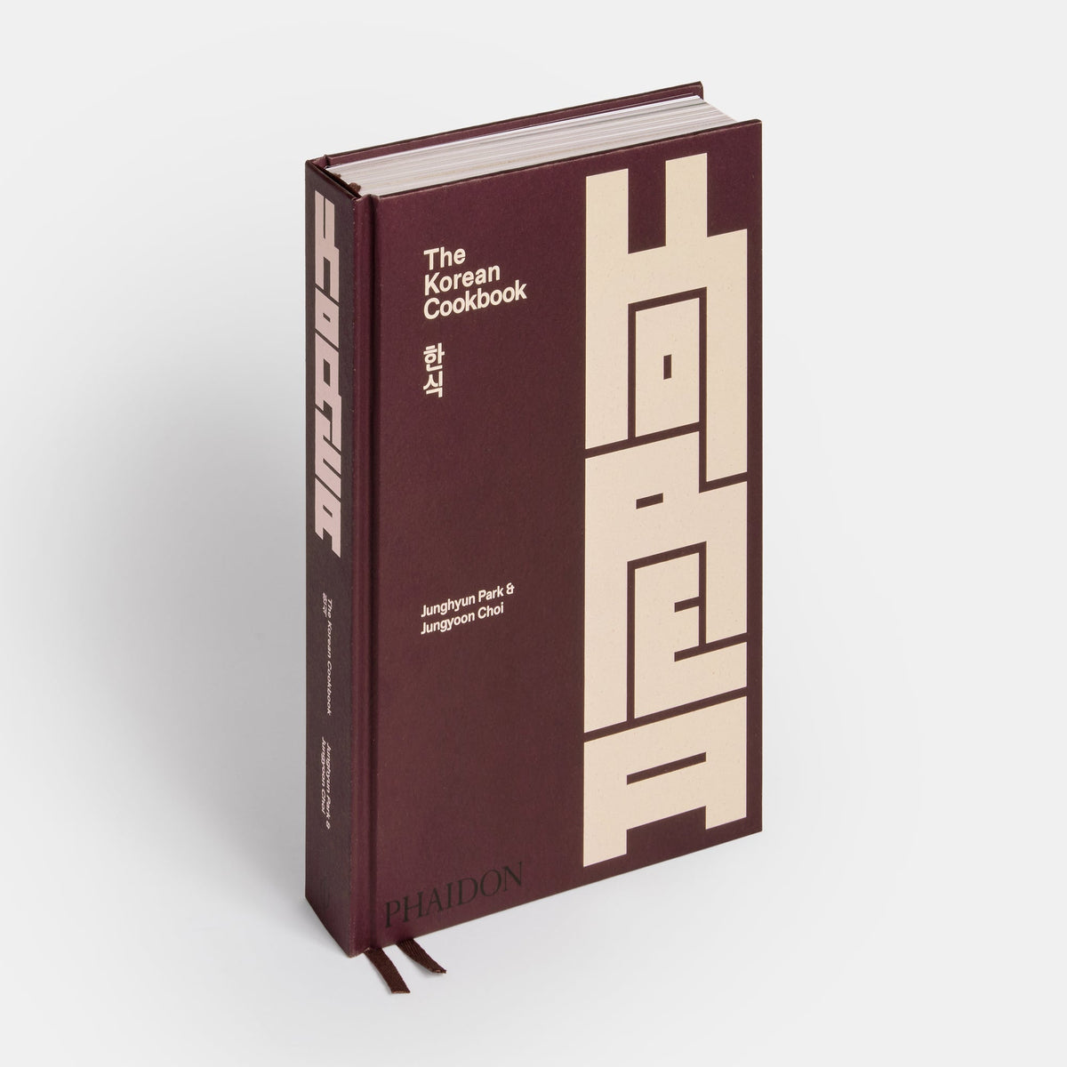 Maroon book titled 'The Korean Cookbook' with white text on a light gray background