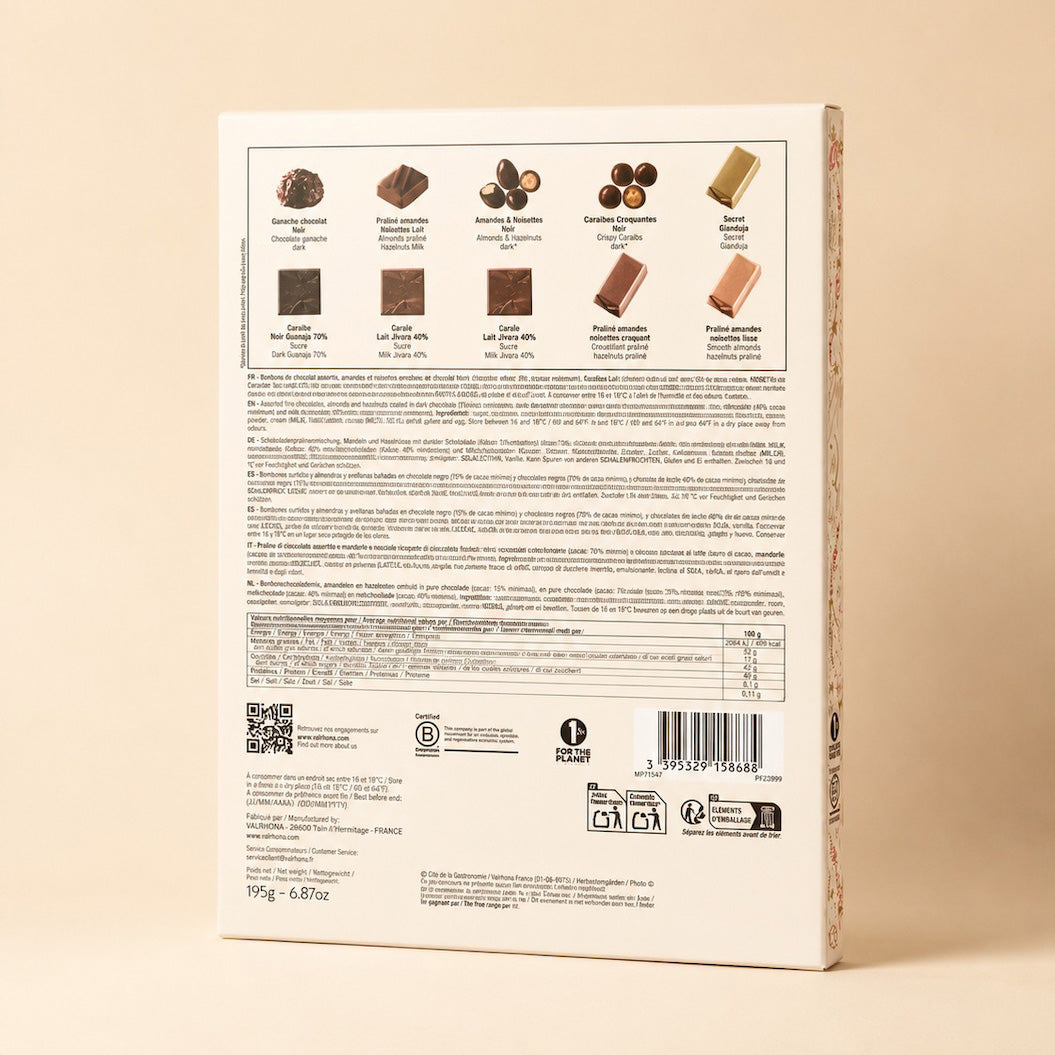 The back of a white chocolate box, showing various chocolate varieties pictured at the top, extensive ingredient and nutritional information in French, a QR code, and a barcode, set against a solid beige background.