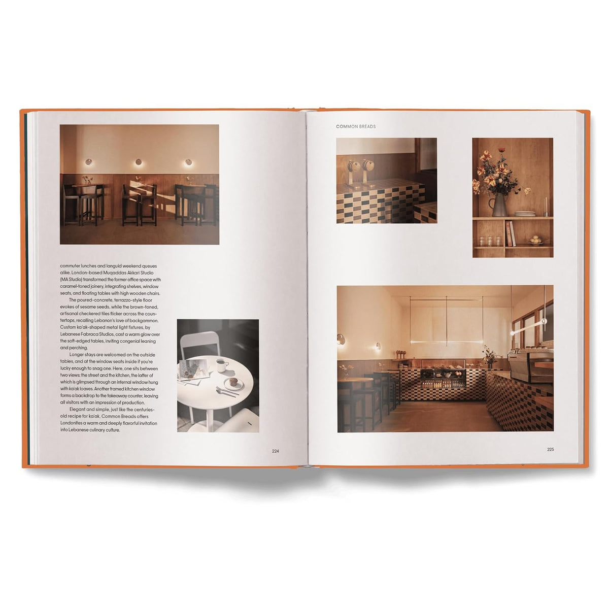 An open architectural or design book showing two interior design pages with photographs of dining and kitchen spaces, photographed against a clean white background.