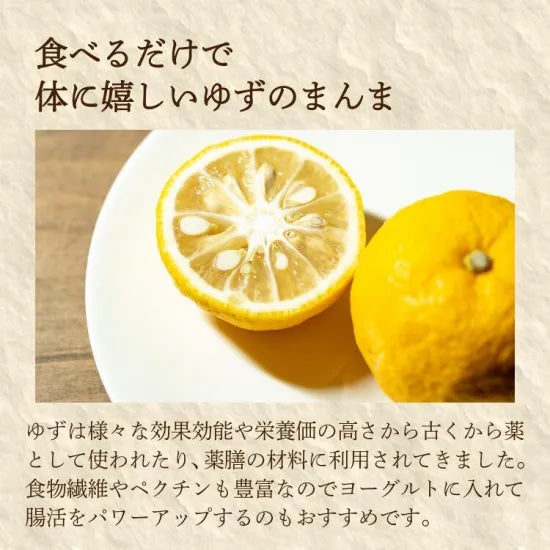 Two yuzus on a white plate with Japanese text on a beige background