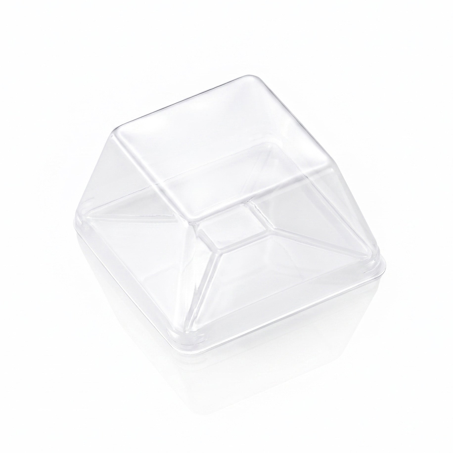 A clear plastic square cup with a slanted, pyramid-like top, shown on a clean white background with a soft reflection.