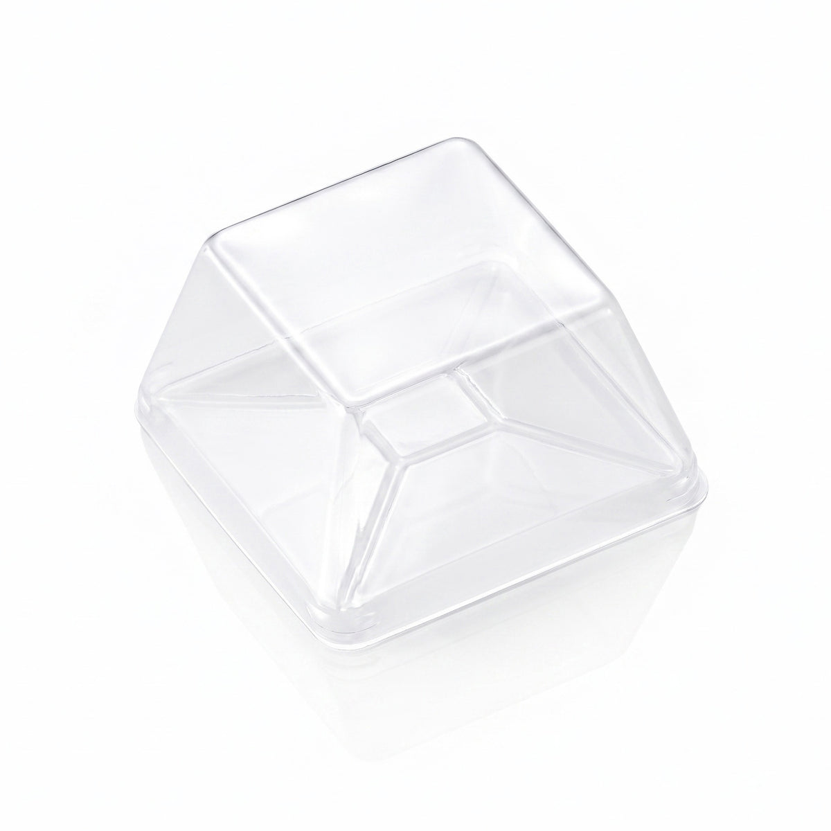 A clear plastic square cup with a slanted, pyramid-like top, shown on a clean white background with a soft reflection.