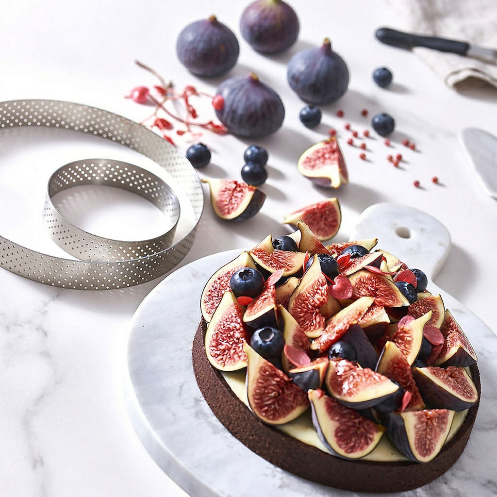 Fruit tart with figs and blueberries on a marble surface