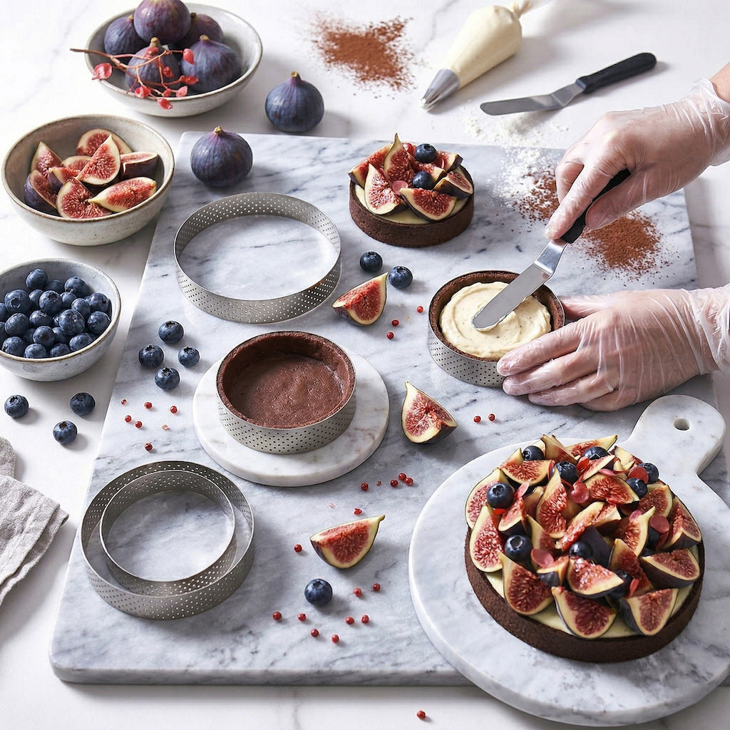 Person preparing a dessert with figs and blueberries on a marble surface