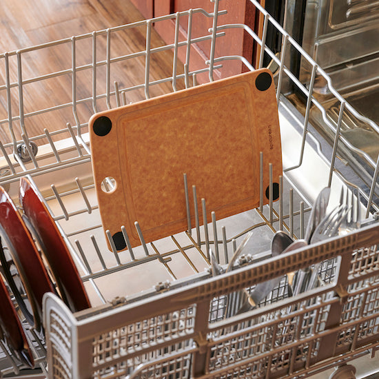 Dishwasher rack with Epicurean all-in-one cutting board and knives inside