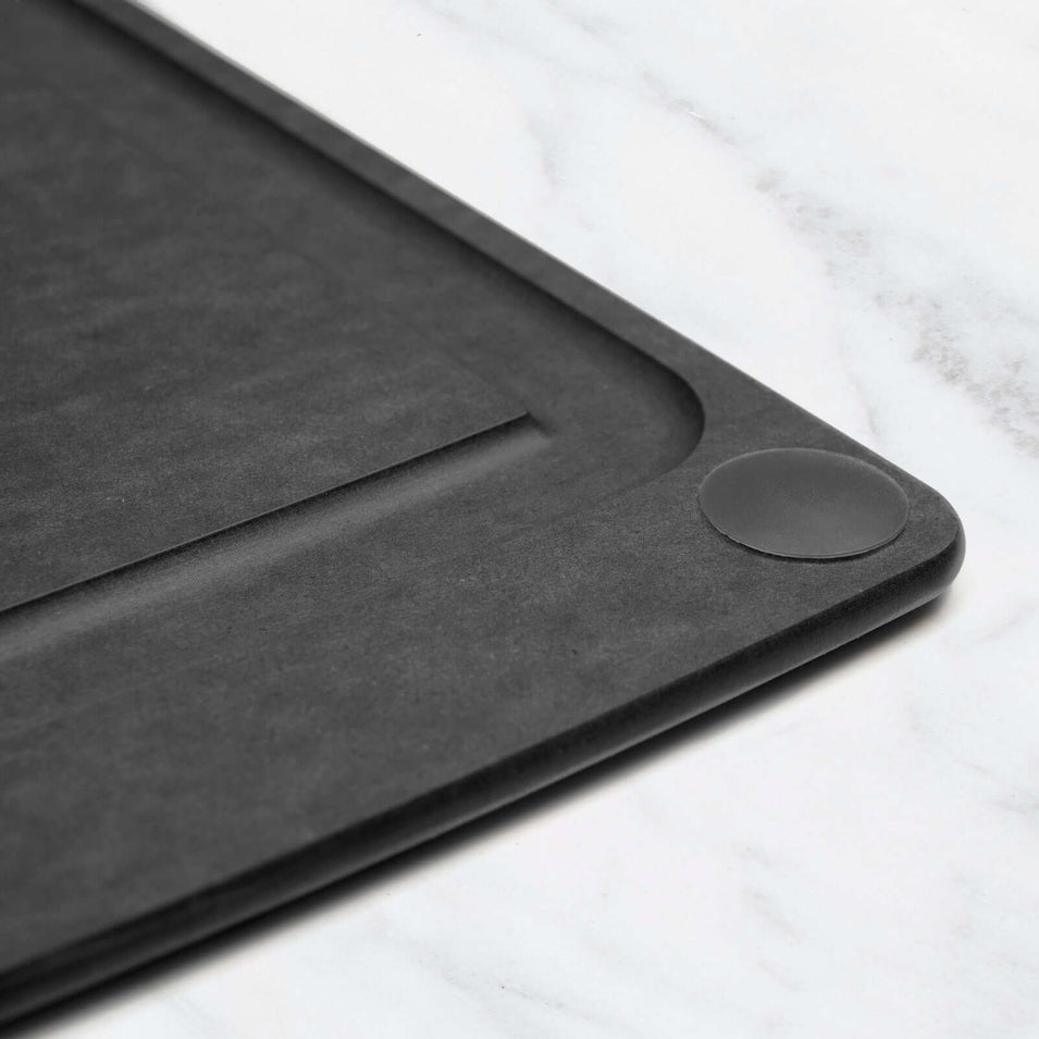 Black non-slip feet from the Epicurean all-in-one series cutting board on a white marble surface