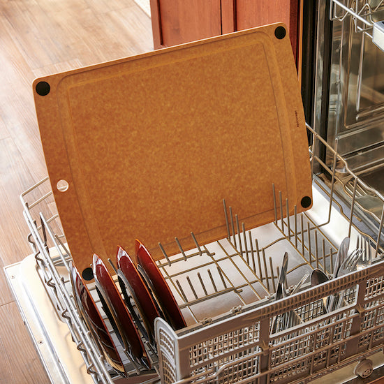 Dishwasher with cutlery rack and Epicurean natural all-in-one cutting board inside