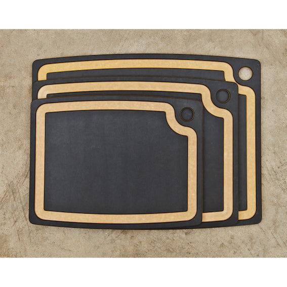 Set of black Epicurean gourmet cutting boards on a beige surface