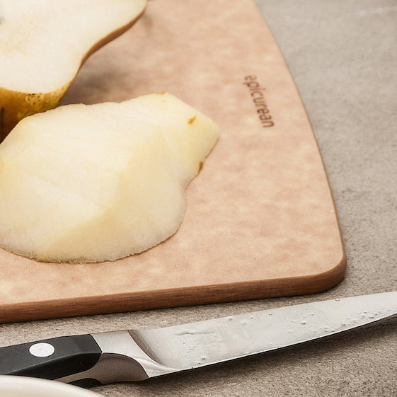Pears on a Epicurean kitchen series cutting board with a knife, branded 'Epicurean' visible