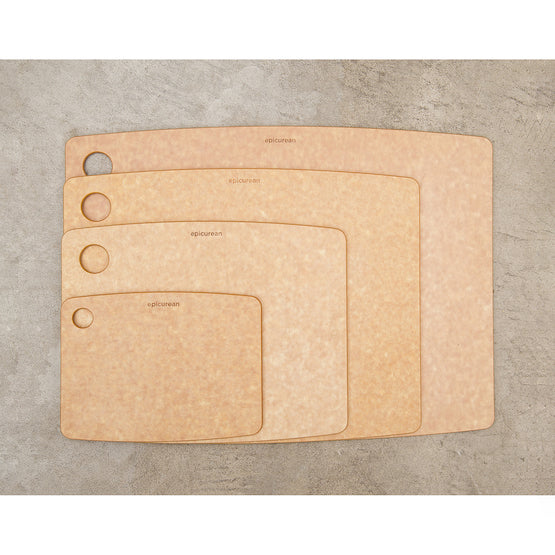Set of four Epicurean kitchen series cutting boards in natural colour on a gray surface
