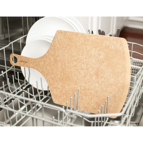 Epicurean pizza peel inside a dishwasher with dishes in the background