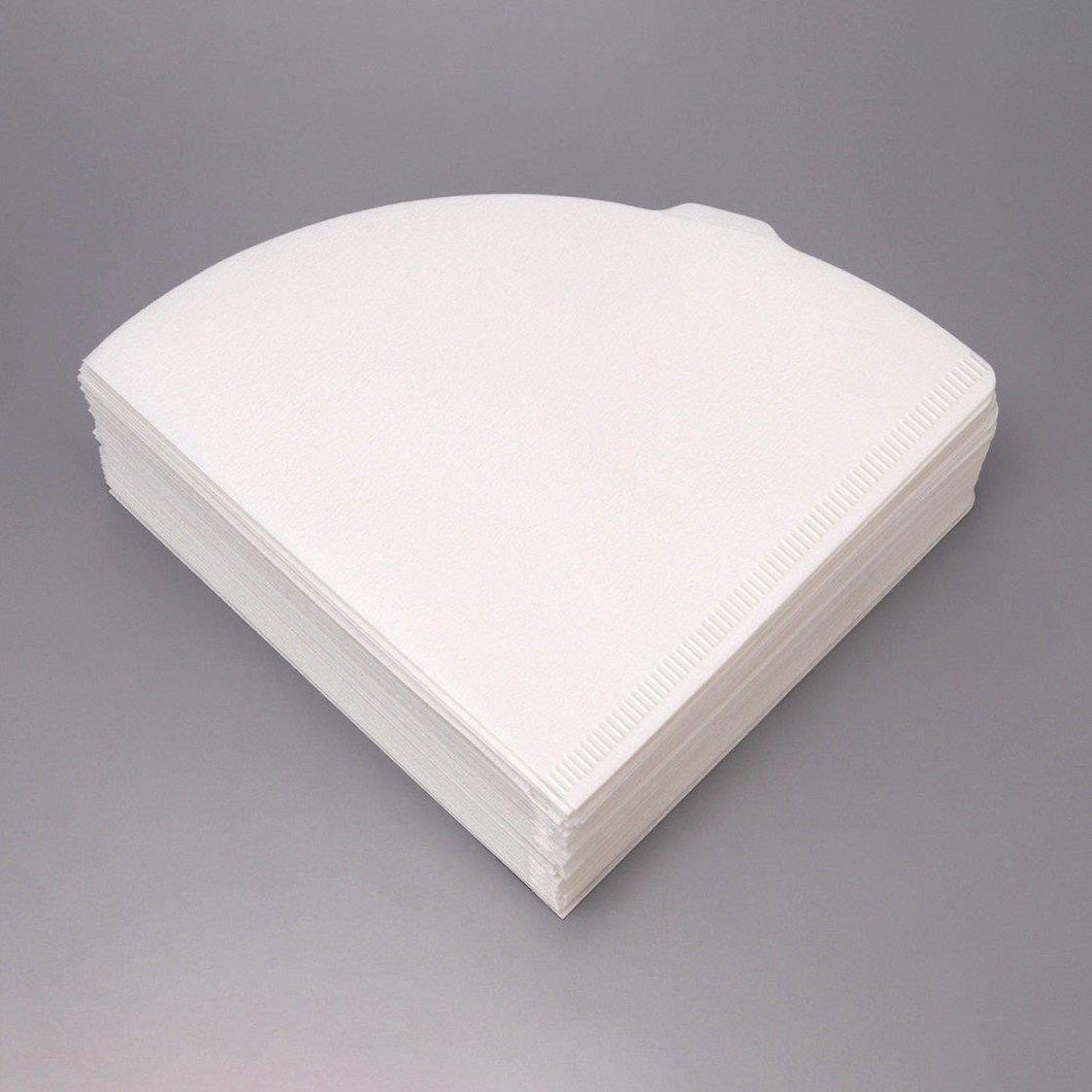 A stack of Hario white paper cone coffee filter baskets, commonly used for drip coffee makers, photographed on a neutral gray background. VCF-02-100W