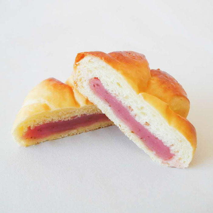 Bun with sakura bean paste filling on a white background
