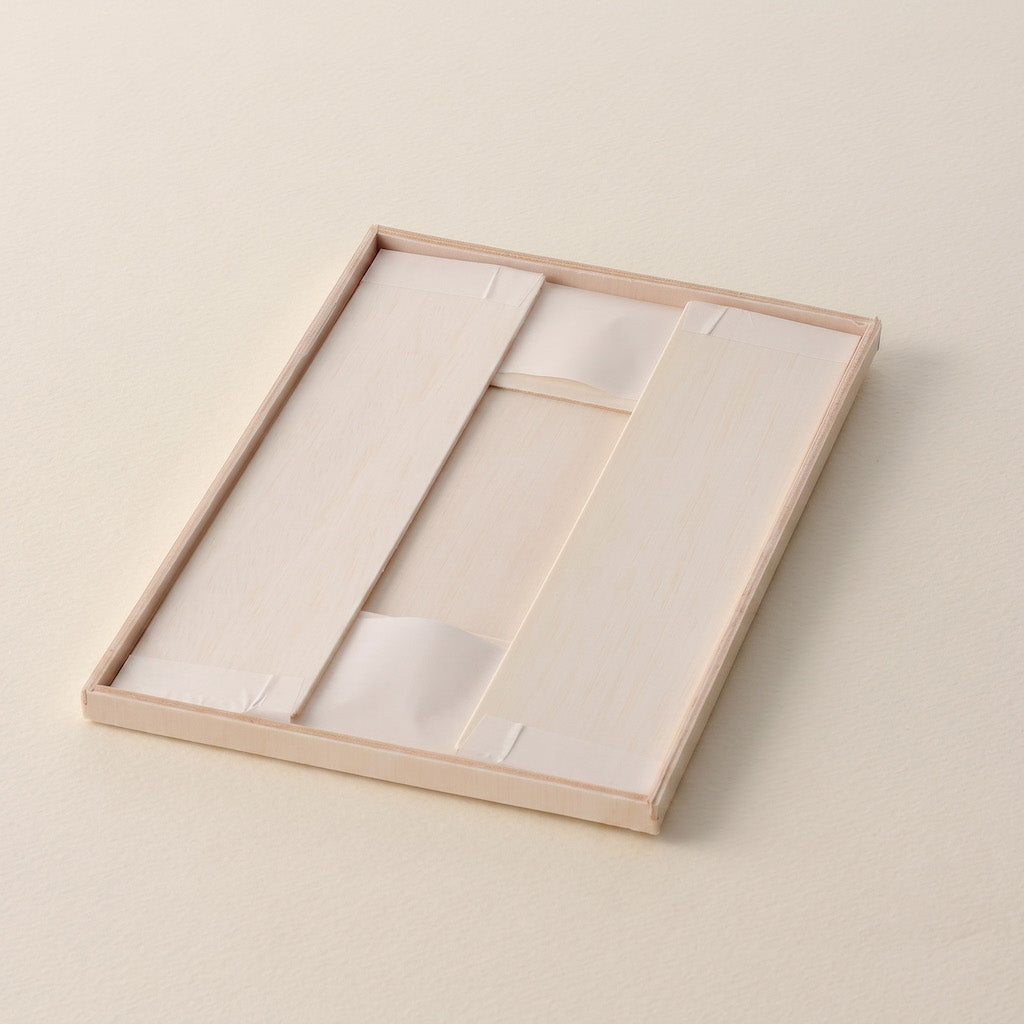 A rectangular light wood tray with a white insert, photographed on a matching light beige textured background.