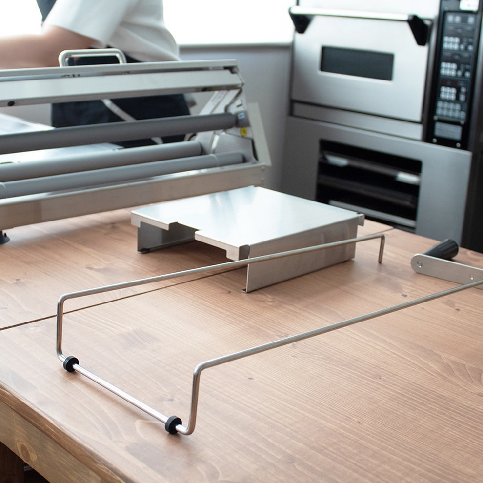 Metal stand on a wooden surface with a blurred background