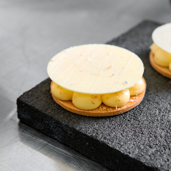 Pastry with cream filling on a dark surface