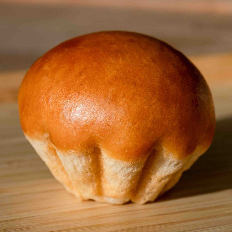 Round bread roll on a wooden surface