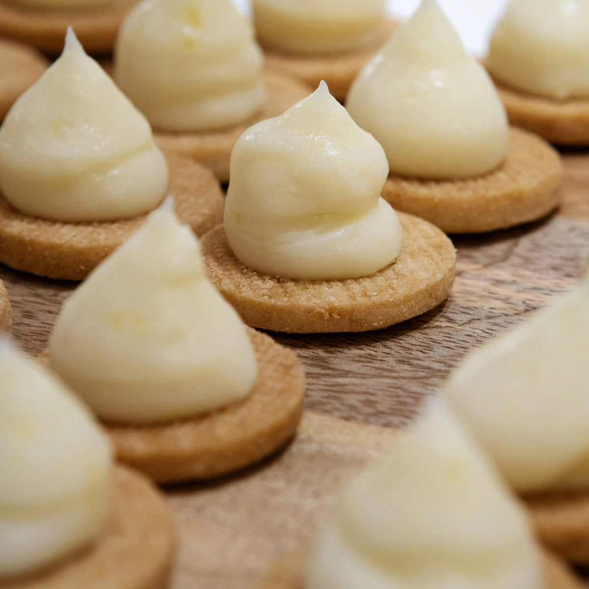Cookies with cream filling on a wooden surface