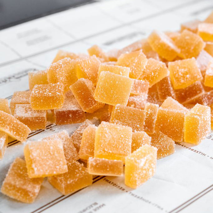 Gummy candy cubes on a newspaper background