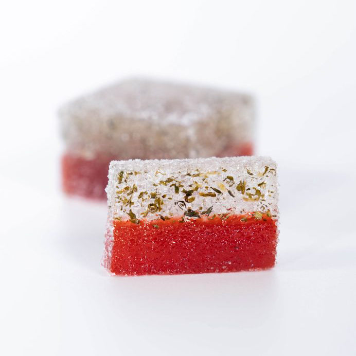 Two layered pate a fruit with red, white, and green layers on a white background