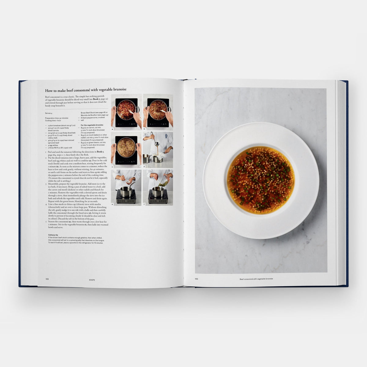 An open cookbook spread showing a recipe page on the left with text and small photos, and a large food photography panel on the right featuring a white plate with a reddish-brown sauce on a light marble background.