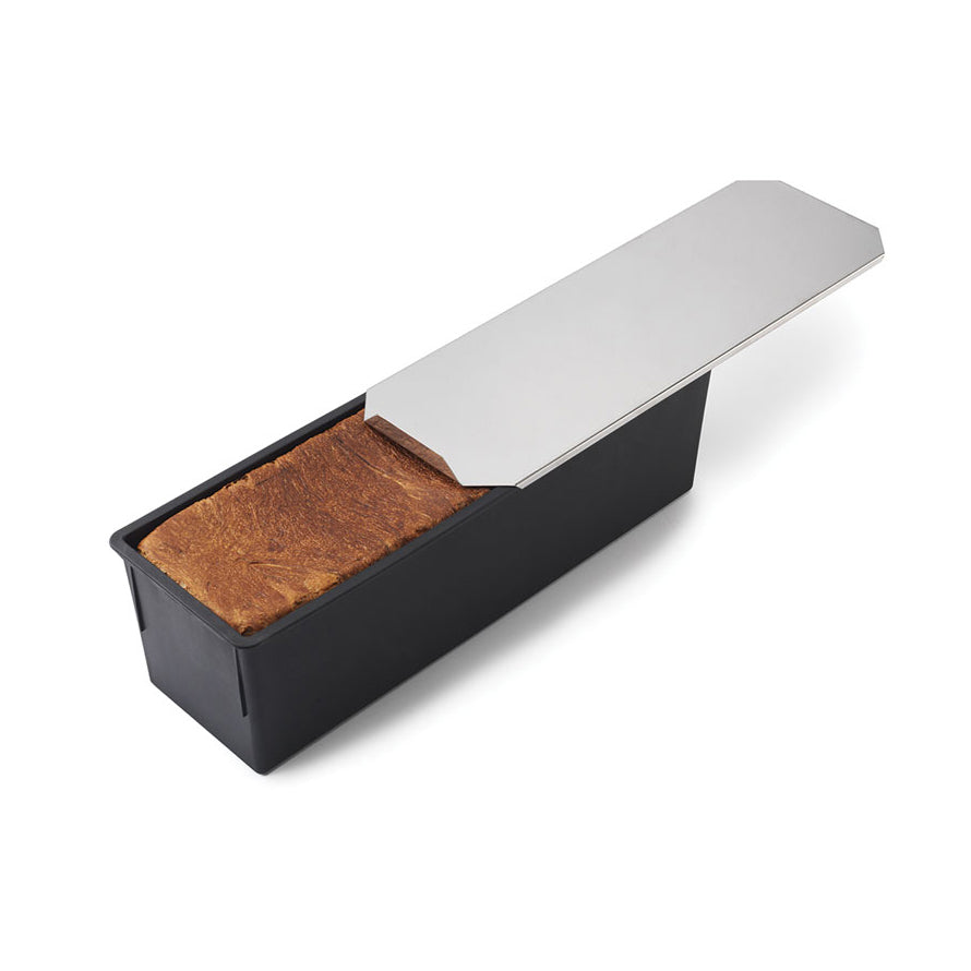 Rectangular black Matfer bread and loaf pan with a metal lid on a white background