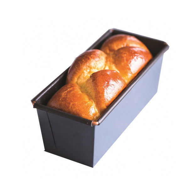Baked bread in a Matfer loaf pan on a white background