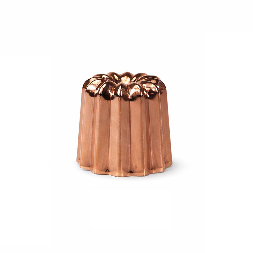 Copper canele mold on a white background